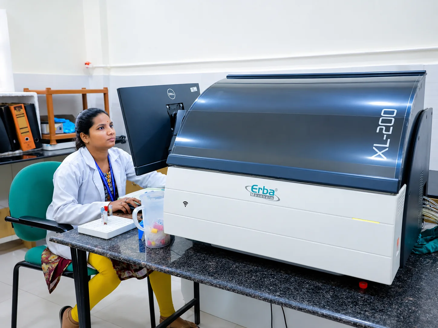 Technician operating the biochemistry auto-analyzer