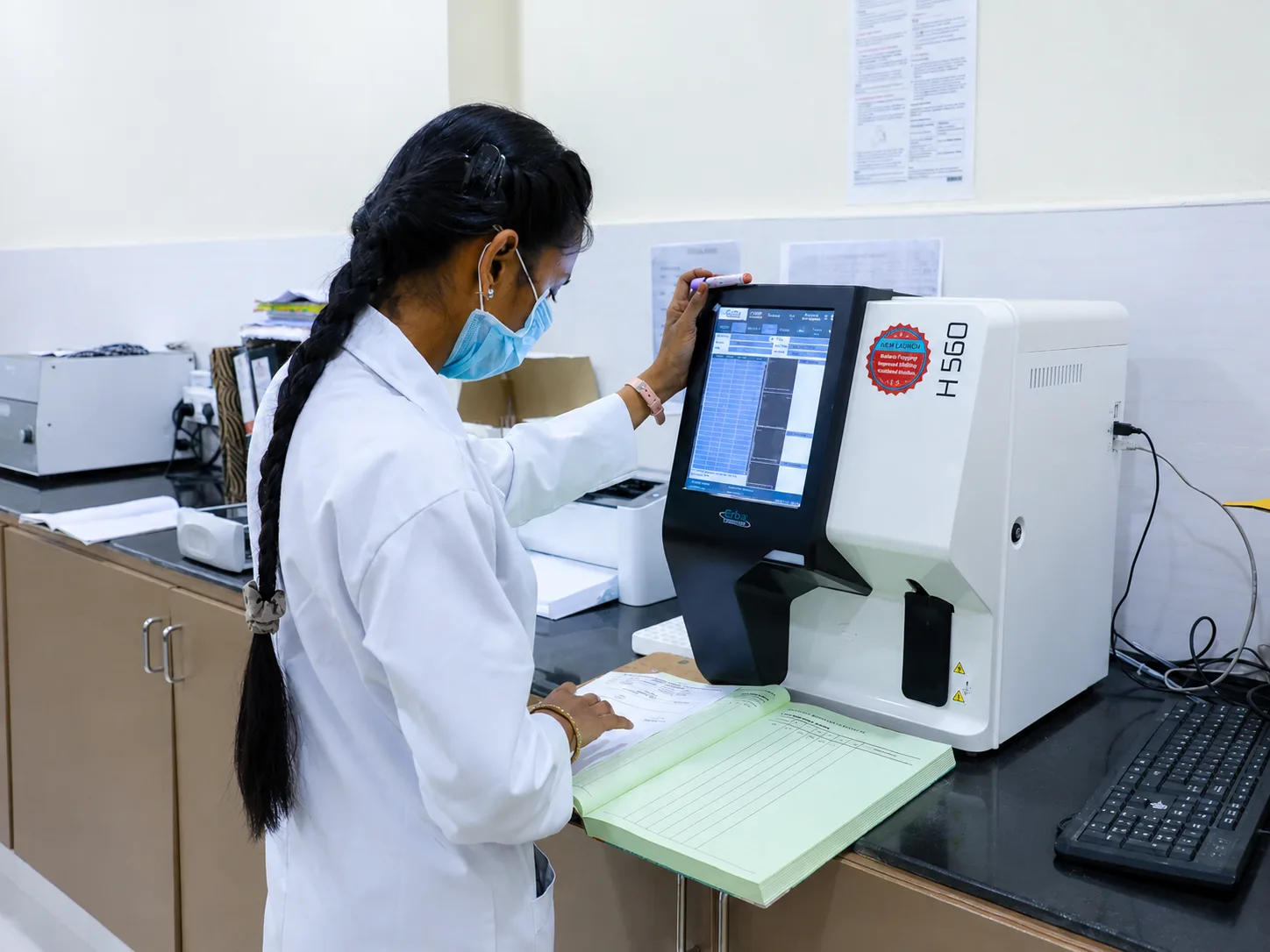 Technician operating the haematology analyzer